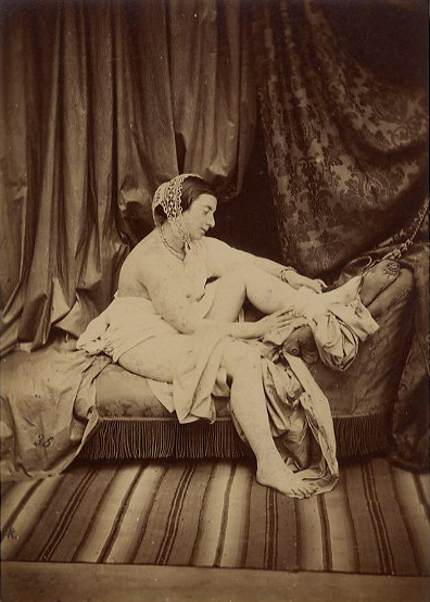 Female Nude Taking off Stocking on Chaise Lounge