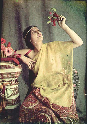 Woman Holding up Berries or Grapes