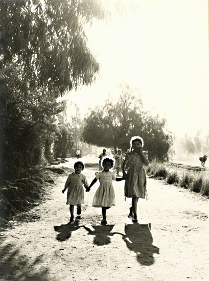Three Egyptian Girls on a Dirt Road near a Canal
