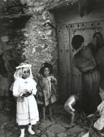 Click for details about Smith - Lorenza Curiel in White First Communion Dress Waiting for Her Mother to Lock Door (from 'Spanish Village') Smith - Lorenza Curiel in White First Communion Dress Waiting for Her Mother to Lock Door (from 'Spanish Village')
