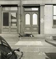 Henle - Man Lying on Stoop of New York City Brownstone