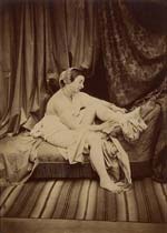 Female Nude Taking off Stocking on Chaise Lounge
