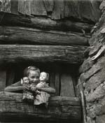 W. Eugene Smith - Child Hugging Her Dolls, Blue Ridge Mountains, NC