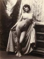 Guglielmo Pluschow - Pensive Standing Female Nude with Drapes and Bureau