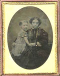 Anonymous - Woman with Long Necklace Holding Her Child