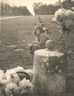 Children Sitting with Flowers