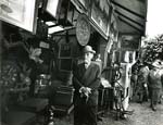 Marvin B. Winter - Man Standing in Antique Shop, Paris