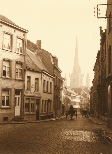 Leonard Misonne - A Cobblestone Street with Horse Carriages in Nivelles, Belgium