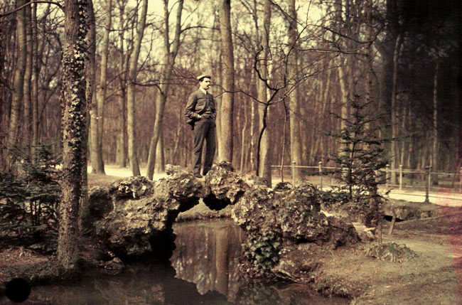 Anonymous - Man Standing on a Rocky Bridge over a Stream with Cigarette in His Mouth Anonymous - Man Standing on a Rocky Bridge over a Stream with Cigarette in His Mouth