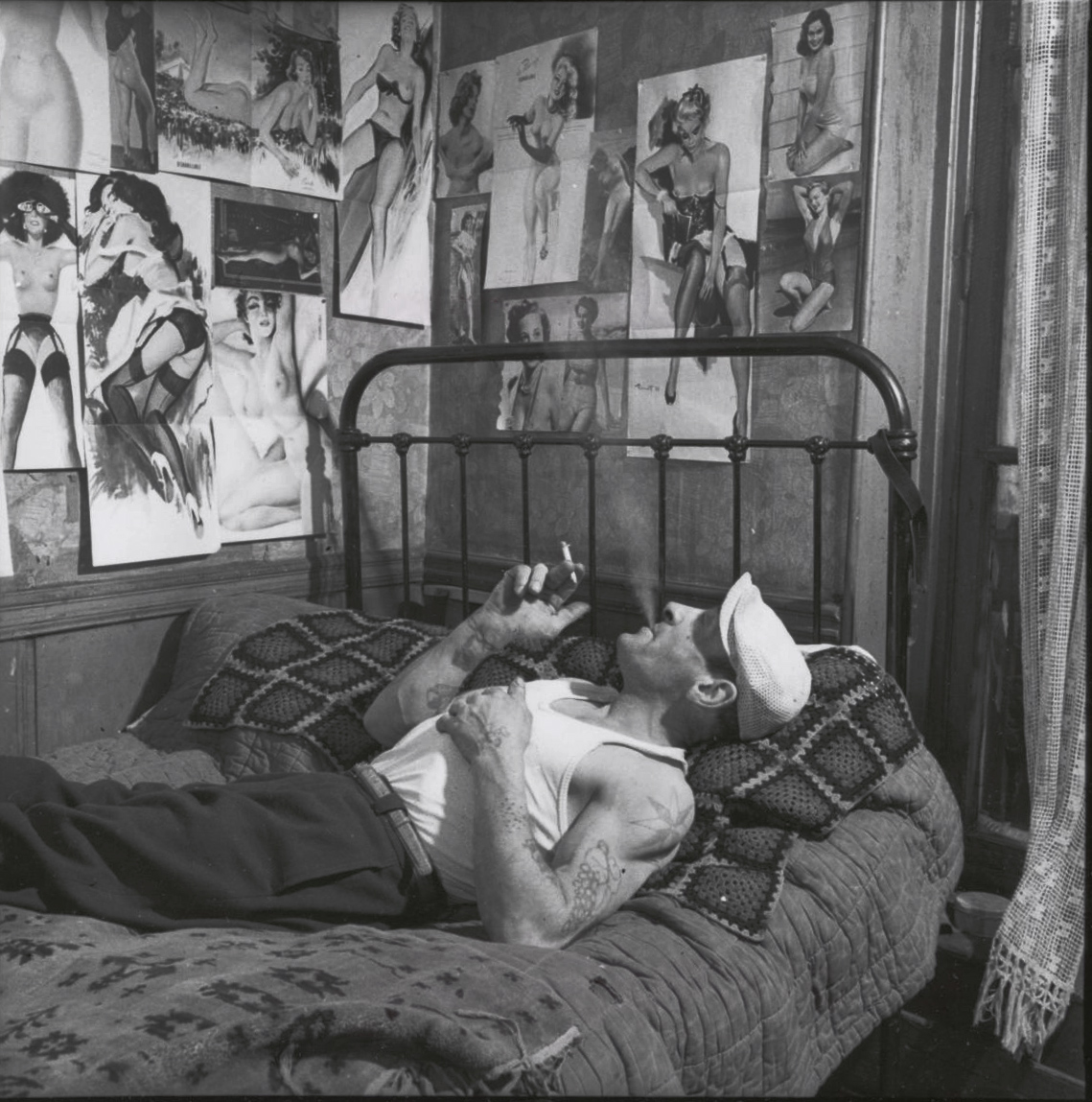 Robert Doisneau - Tatooed Man Smoking on Bed Robert Doisneau - Tatooed Man Smoking on Bed