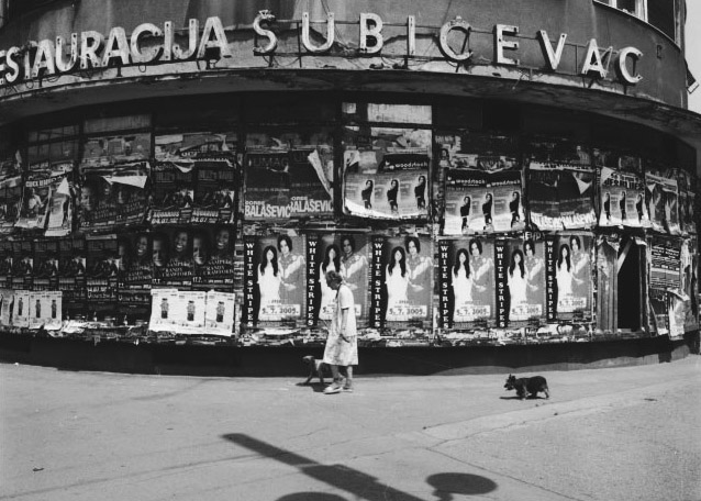 Photo Detail - Stanko Abadžic - Old Woman and Dogs in Front of Posters